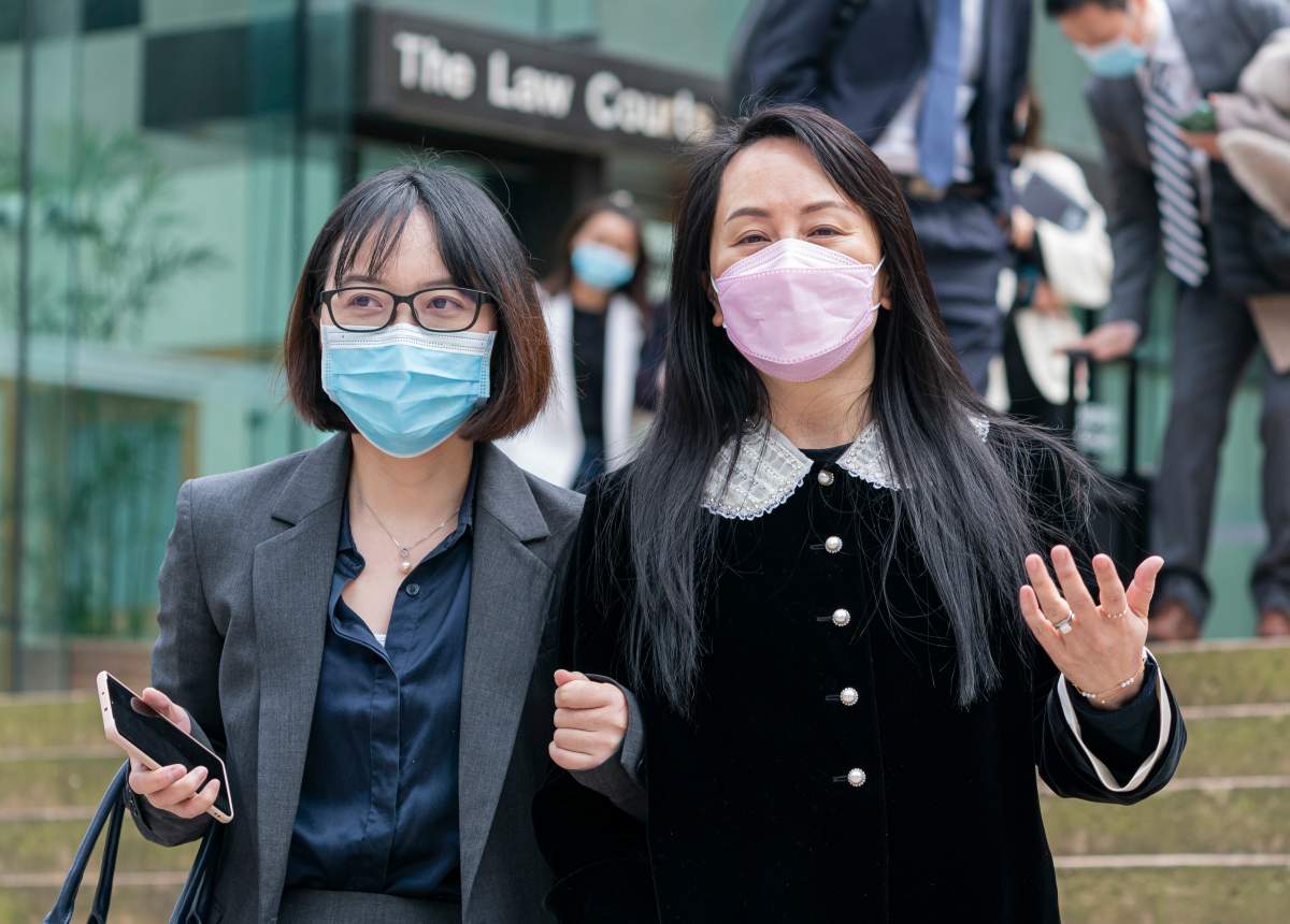 Meng Wanzhou, chief financial officer of Huawei, leaves B.C. Supreme Court with an acquaintance during a lunch break at her extradition hearing, in Vancouver, B.C., Thursday, April 1, 2021. 
