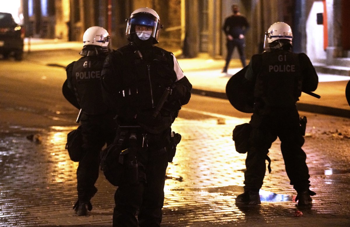 Montreal police in full riot gear clearing streets as protesters riot against the return of the 8'o'clock curfew in Montreal, Que., Sunday, April 11, 2021. 