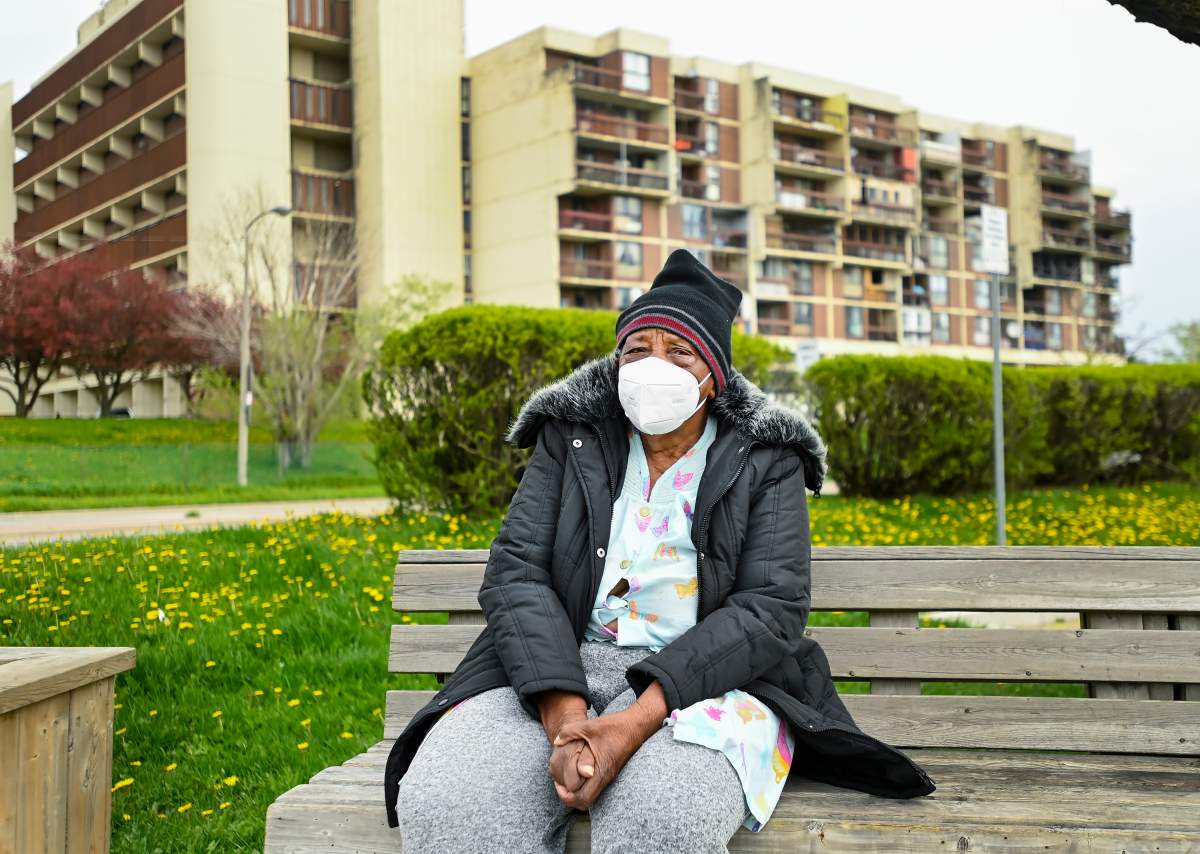 An elderly woman rests on a bench in a neighbourhood that Ontario has designated a postal code hotspot during the COVID-19 pandemic in Toronto on Monday, May 3, 2021. 