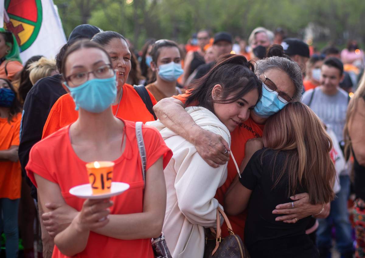 People gather in recognition of the discovery of children’s remains at the site of a former residential school in Kamloops, B.C., in Edmonton Alta., on Monday, May 31, 2021.