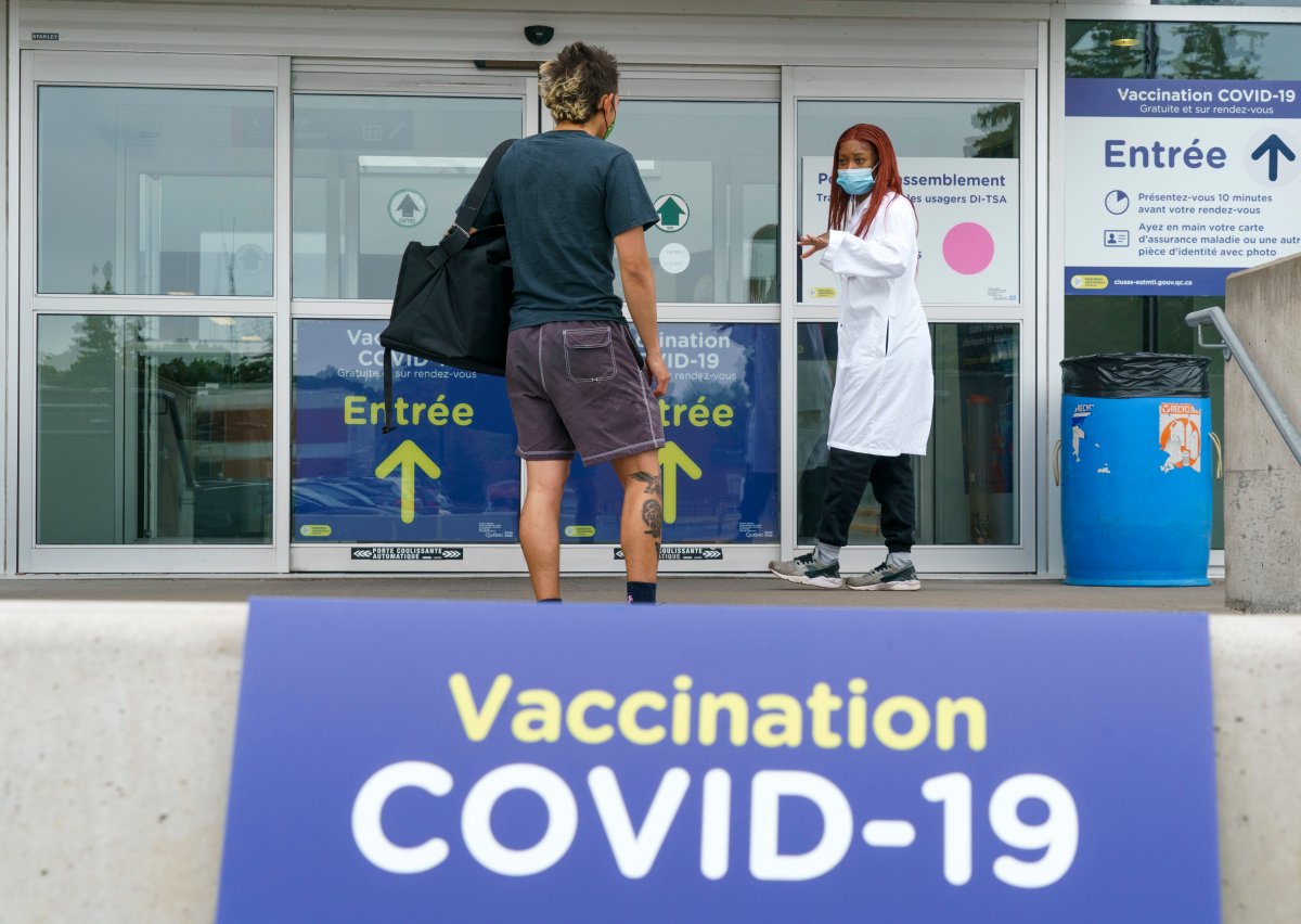 A man is welcomed at a COVID-19 vaccination clinic in Montreal, on Tuesday, June 1, 2021.
