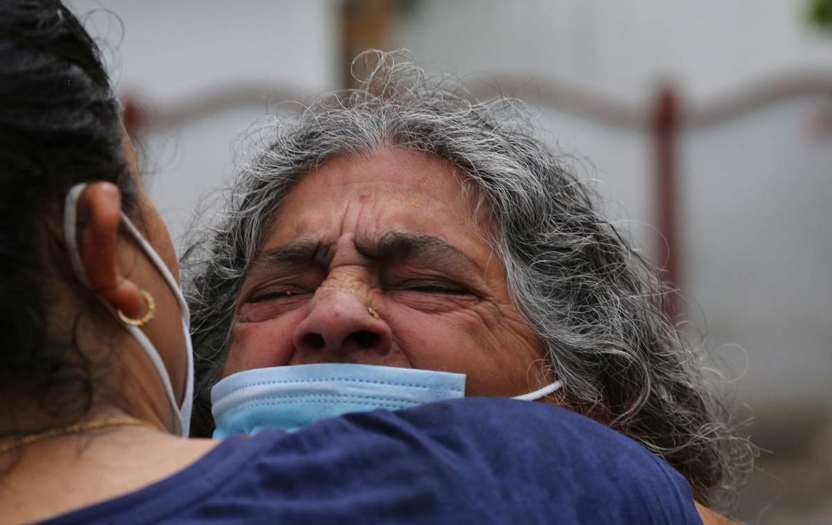 Mother of a politician Rakesh Pandita, who was killed late Wednesday, mourns at their residence in Jammu, India, Thursday, June.3, 2021. Assailants fatally shot the politician belonging to India’s ruling party in disputed Kashmir, police said Thursday, blaming separatist rebels for the attack. The unidentified assailants fired at Pandita late Wednesday in the southern town of Tral, where he was visiting a friend, police said. He was declared dead in a hospital. (AP Photo/Channi Anand).
