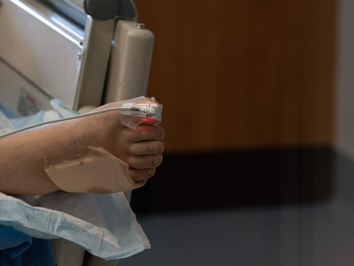A patient's foot is pictured as they lay in bed in the COVID-19 Intensive Care Unit at Surrey Memorial Hospital in Surrey, B.C., Friday, June 4, 2021. THE CANADIAN PRESS/Jonathan Hayward.