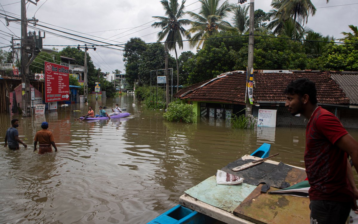 Sri Lankans stranded due to floods travel in a boat in an inundated street following heavy rainfall at Malwana, on the outskirts of Colombo, Sri Lanka, June 5, 2021.