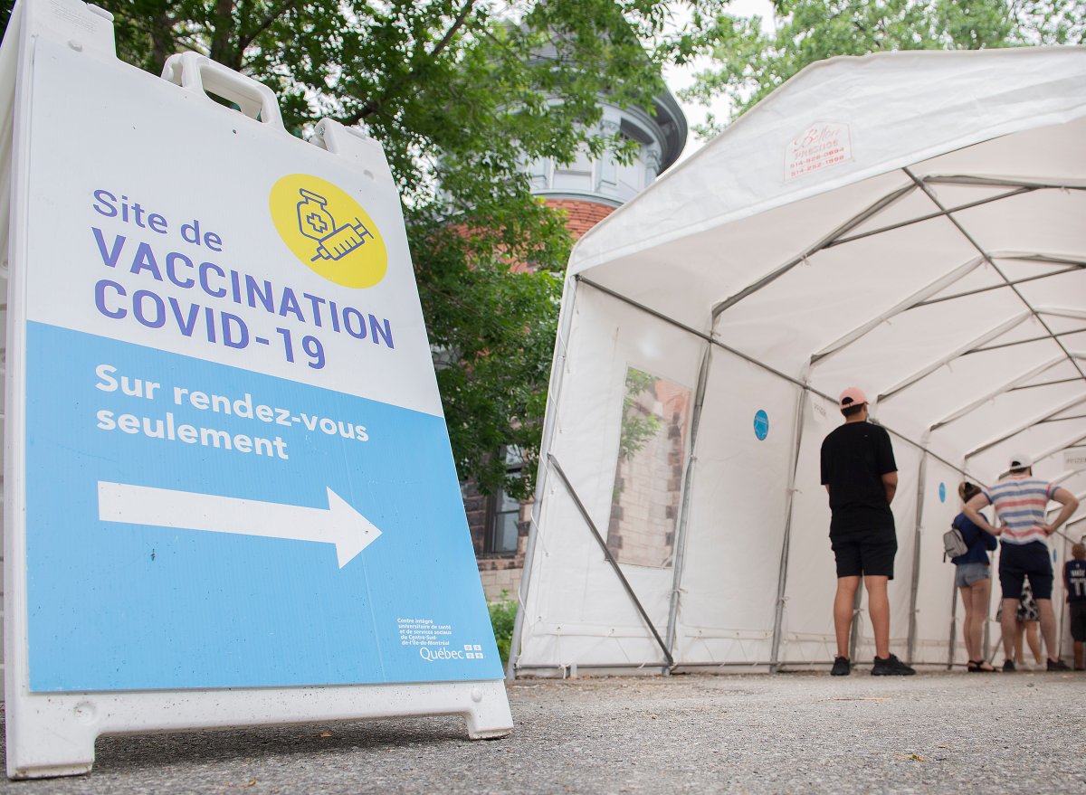 People wait in line for a COVID-19 vaccination shot in Montreal, Saturday, June 5, 2021, as the COVID-19 pandemic continues in Canada and around the world. 