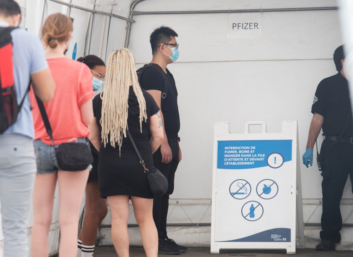 People wait in line for a COVID-19 Pfizer vaccination shot in Montreal, Saturday, June 5, 2021, as the COVID-19 pandemic continues in Canada and around the world. 