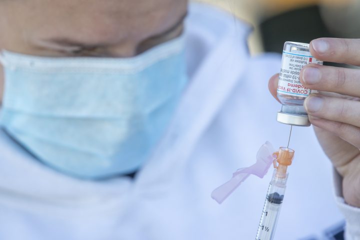 Moderna COVID-19 vaccine is drawn out from a vial before a drive-thru vaccine clinic in Kingston, Ontario on Friday June 4, 2021.