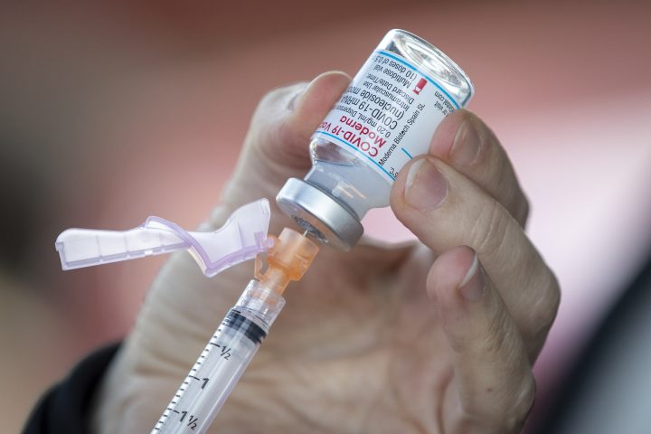 Moderna COVID-19 vaccine is drawn out from a vial before a drive-thru vaccine clinic in Kingston, Ontario on Friday June 4, 2021.