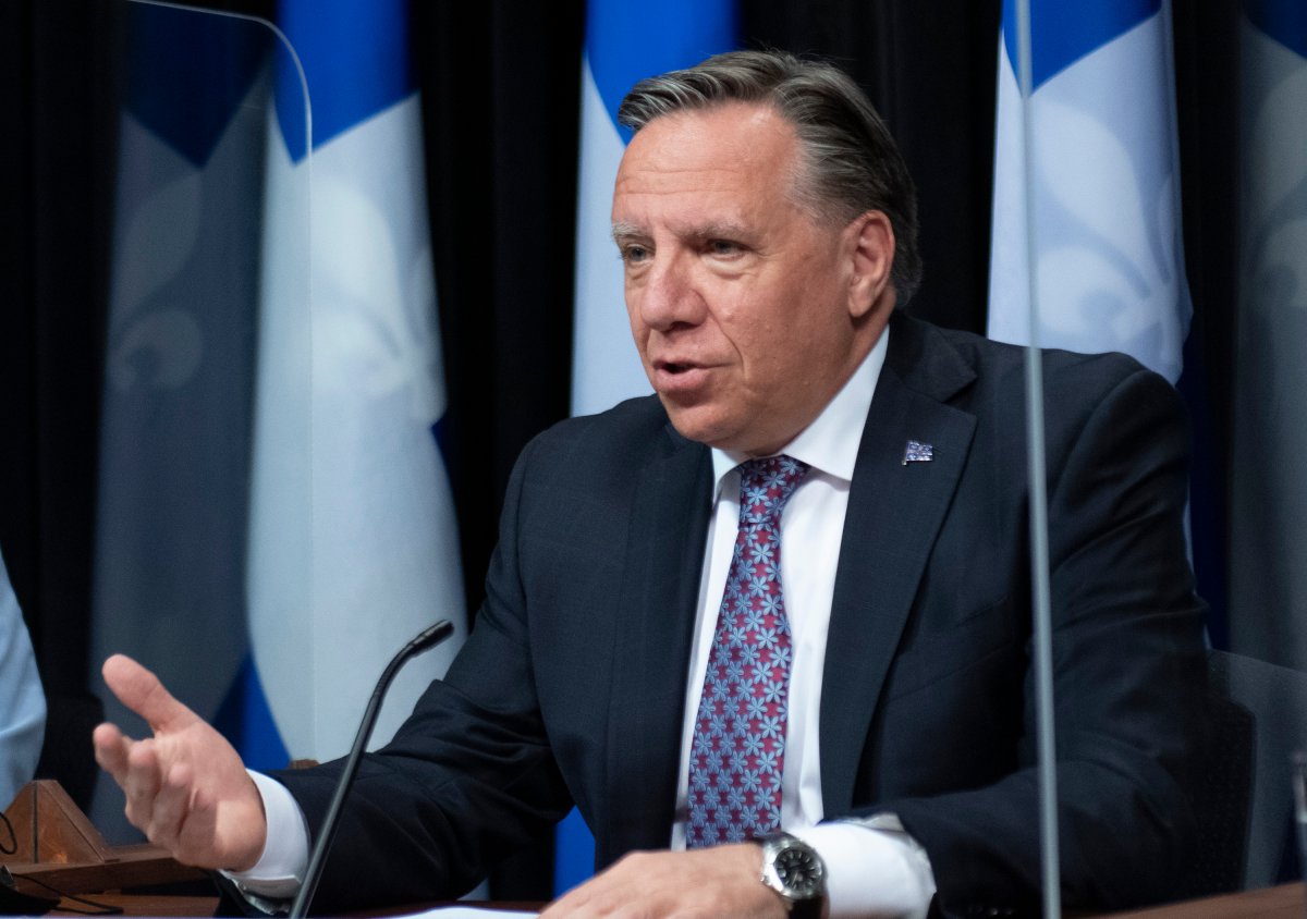 Quebec Premier Francois Legault, left, responds to reporters questions during a news conference on the COVID-19 pandemic, Tuesday, June 8, 2021 at the legislature in Quebec City. 