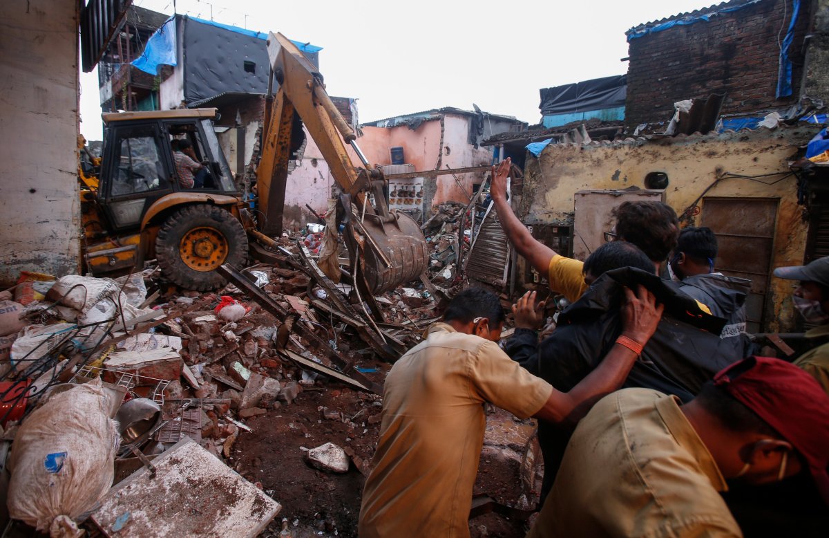 Rescuers clear the debris to find any residents possibly still trapped after a three-story dilapidated building collapsed following heavy monsoon rains n Mumbai, India, Thursday, June 10, 2021. (AP Photo/Rafiq Maqbool).
