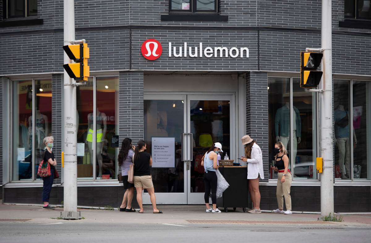 People line up outside a Lululemon Athletica store in Ottawa, as non-essential retail stores re-open with limited in-store capacity, on the first day of Ontario's first phase of re-opening amidst the third wave of the COVID-19 pandemic, on Friday, June 11, 2021. 
