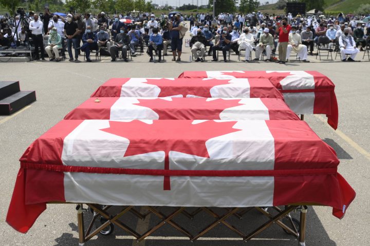 Caskets draped in Canadian flags are on display at a funeral for four Muslim family members killed in a deadly vehicle attack. 