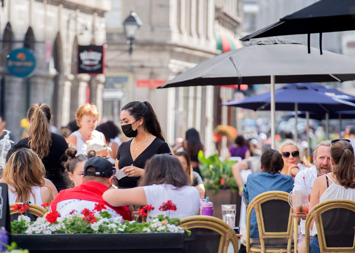 People sit on a terrace in Old Montreal, Sunday, June 13, 2021, as the COVID-19 pandemic continues in Canada and around the world. 