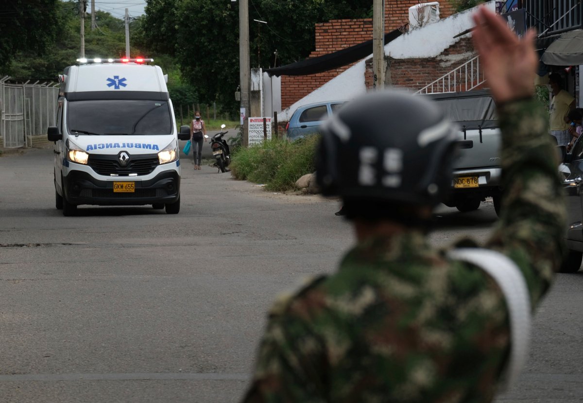 A soldier signals an ambulance as it drives towards the military base where a car bomb exploded in Cucuta, Colombia, Tuesday, June 15, 2021. Colombian authorities still have not confirmed how many were injured in the explosion. (AP Photo/Ferley Ospina).