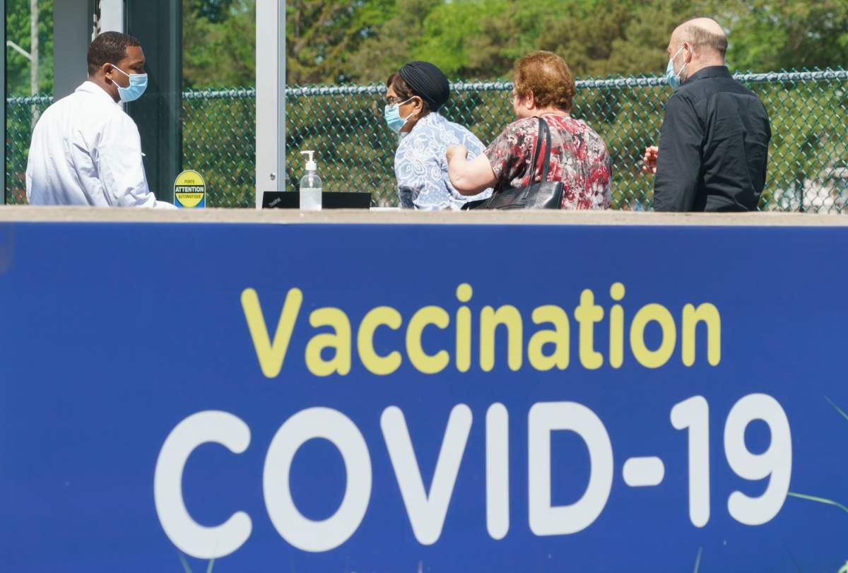 People line up at a COVID-19 vaccination clinic in Montreal, on Wednesday, June 16, 2021.