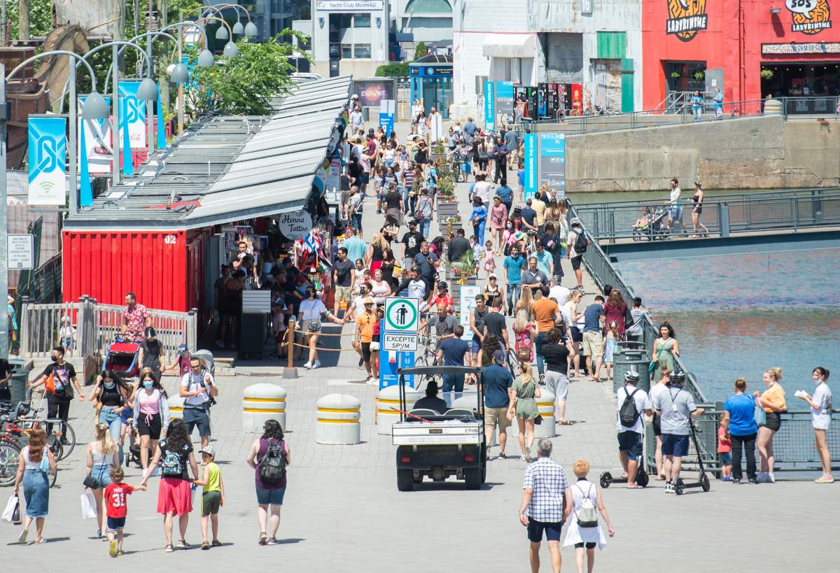 People walk in the Old Port in Montreal, Saturday, June 19, 2021, as the COVID-19 pandemic continues in Canada and around the world. 