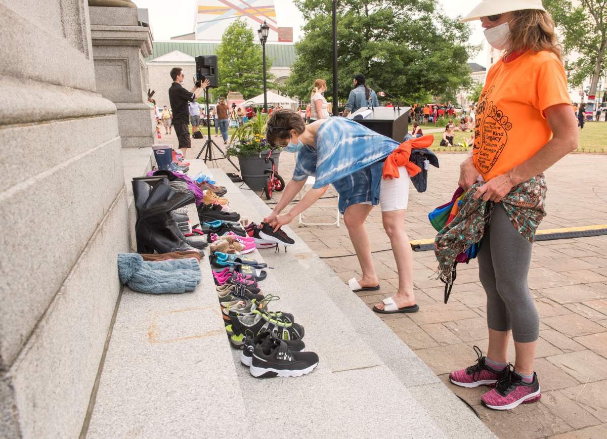 People placed children’s shoes on the front stairs of the New Brunswick legislature as a memorial for the 215 children found at the Kamloops Residential School as part of National Indigenous Peoples Day in Fredericton, N.B., on Monday June 21, 2021.