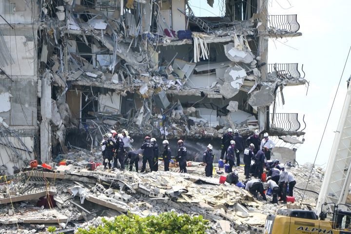 Rescue workers search the rubble of the Champlain Towers South condominium, Saturday, June 26, 2021, in the Surfside area of Miami. The building partially collapsed on Thursday.