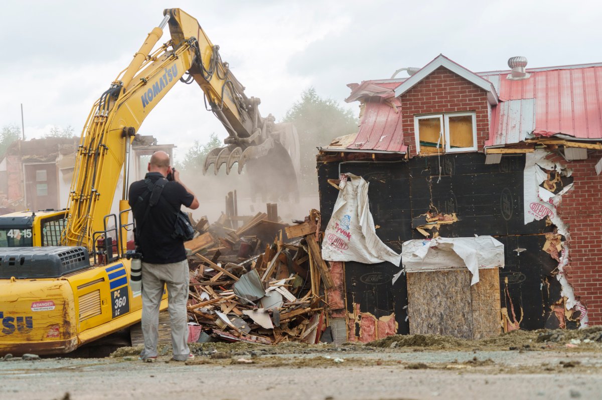 A photographer records the demolition of the Hells Angels bunker in Sherbrooke, Que. on Wednesday, June 30, 2021. The bunker was the site of some notorious crimes during the biker war during the mid 1980's in Quebec. 