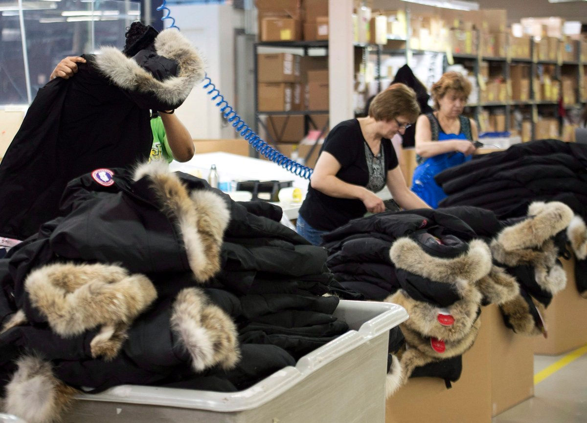 Employees work with Canada Goose jackets at the Canada Goose factory in Toronto on Thursday, April 2, 2015.