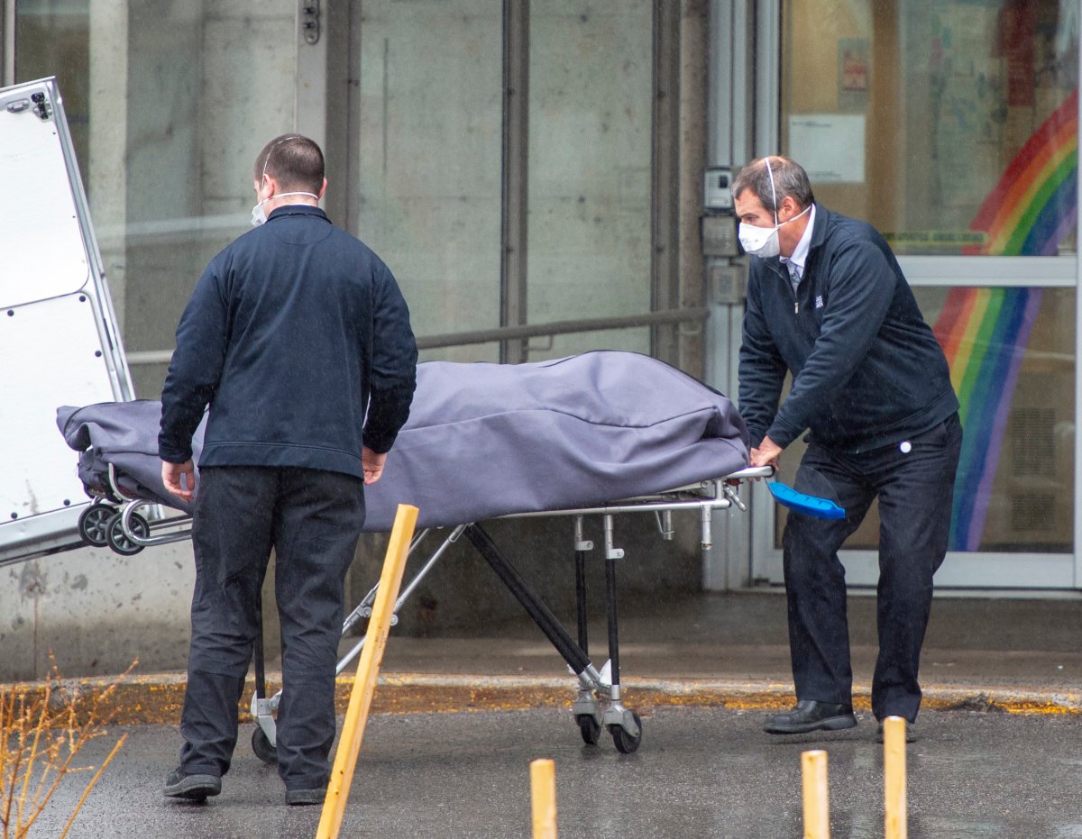Funeral home workers remove a body from the Centre d'hebergement Ste-Dorothee Monday April 13, 2020 in Laval, Que. 