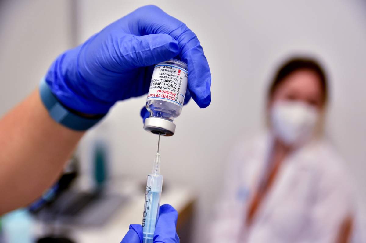 L´HOSPITALET, BARCELONA, SPAIN - 2021/05/14: A nurse prepares to administer the first dose of Moderna vaccine to a member of the public at the La Farga Convention Center.