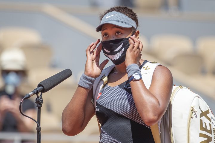 Naomi Osaka of Japan conducts an on-court interview wearing a mask after her victory against Patricia Maria Tig of Romania in the first round of the 2021 French Open on May 30, 2021