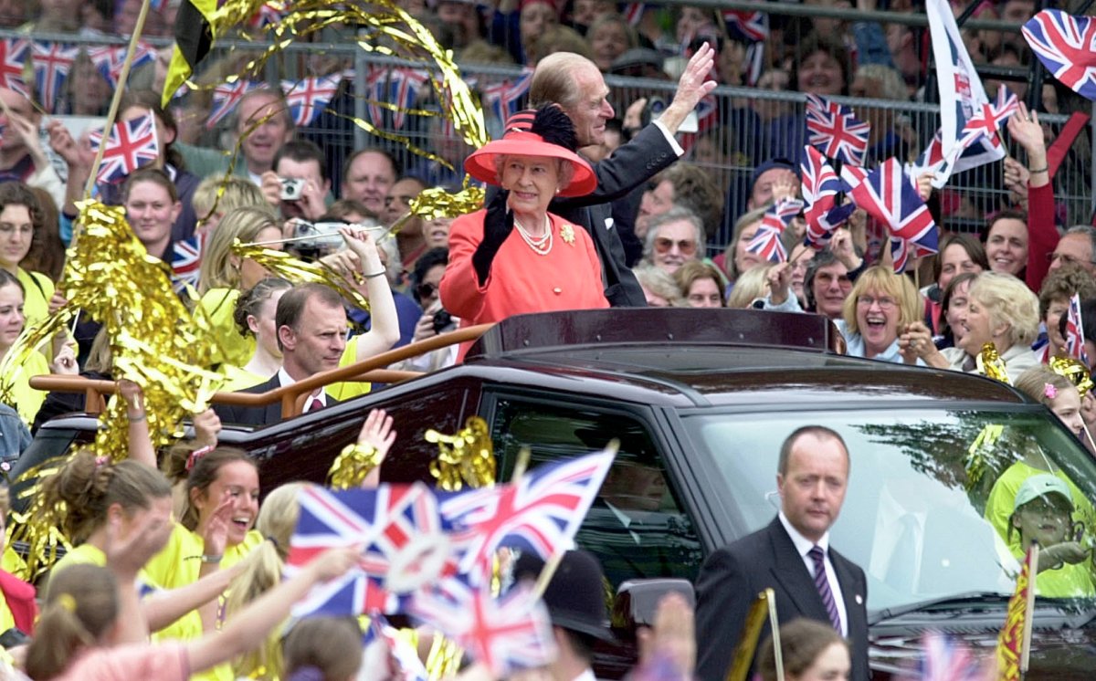 Queen Elizabeth II and Prince Phillip the Duke of Edinburgh ride along the Mall in an open-top car on their way to watch a parade in celebration of the Golden Jubilee on June 4, 2002 in London, England.