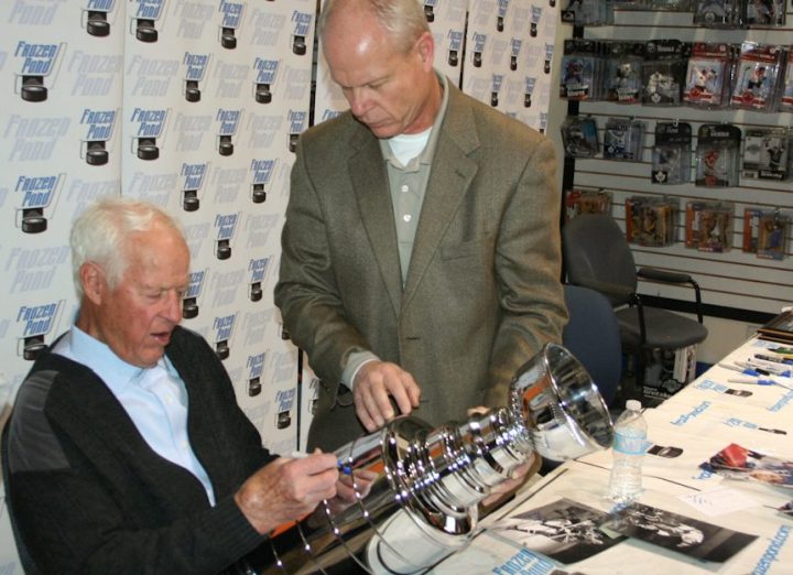 Gordie Howe (left) and Mark Howe (right) during an autograph signing.