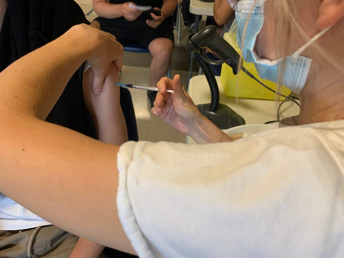 A high school student at Laval Senior Academy receiving the COVID-19 vaccine in school