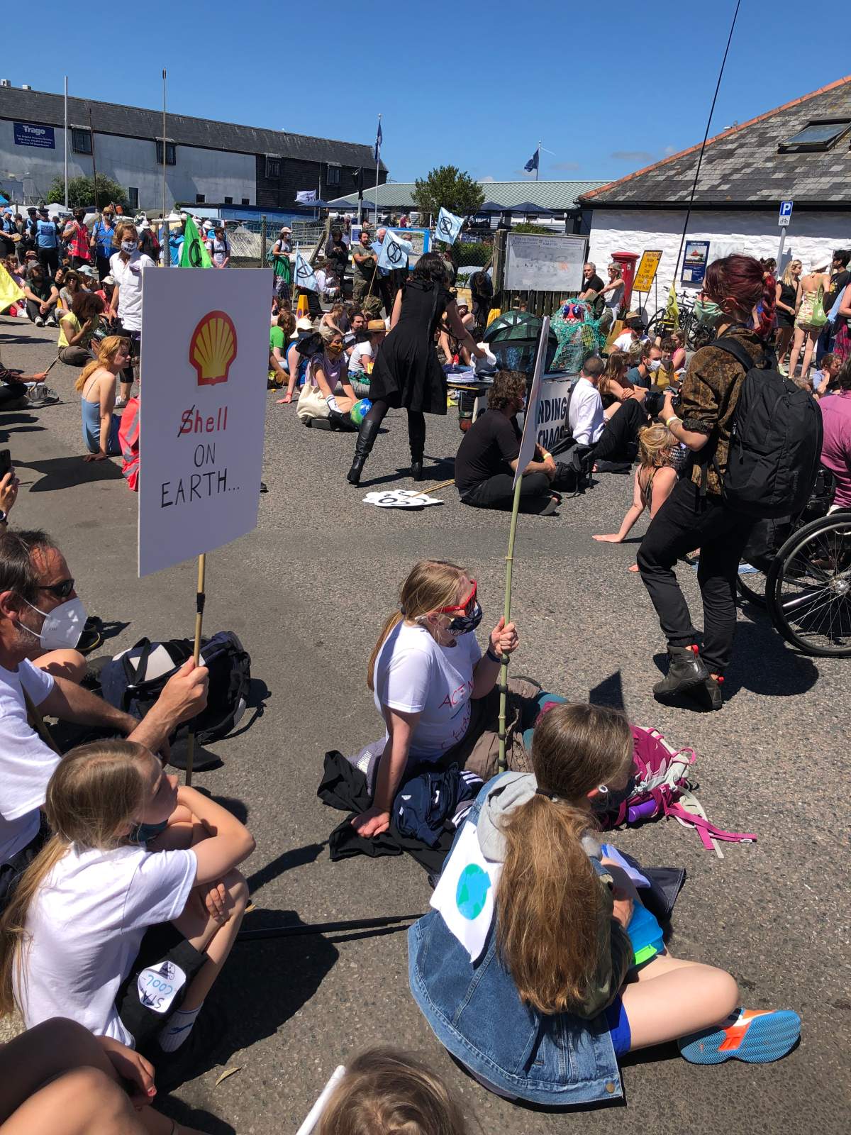 Protesters gathered outside the media centre at the G7 in Falmouth, England.