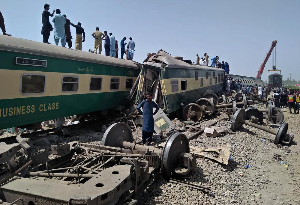 Soldiers and volunteers work at the site of a train collision in Ghotki district in southern Pakistan, Monday, June 7, 2021.