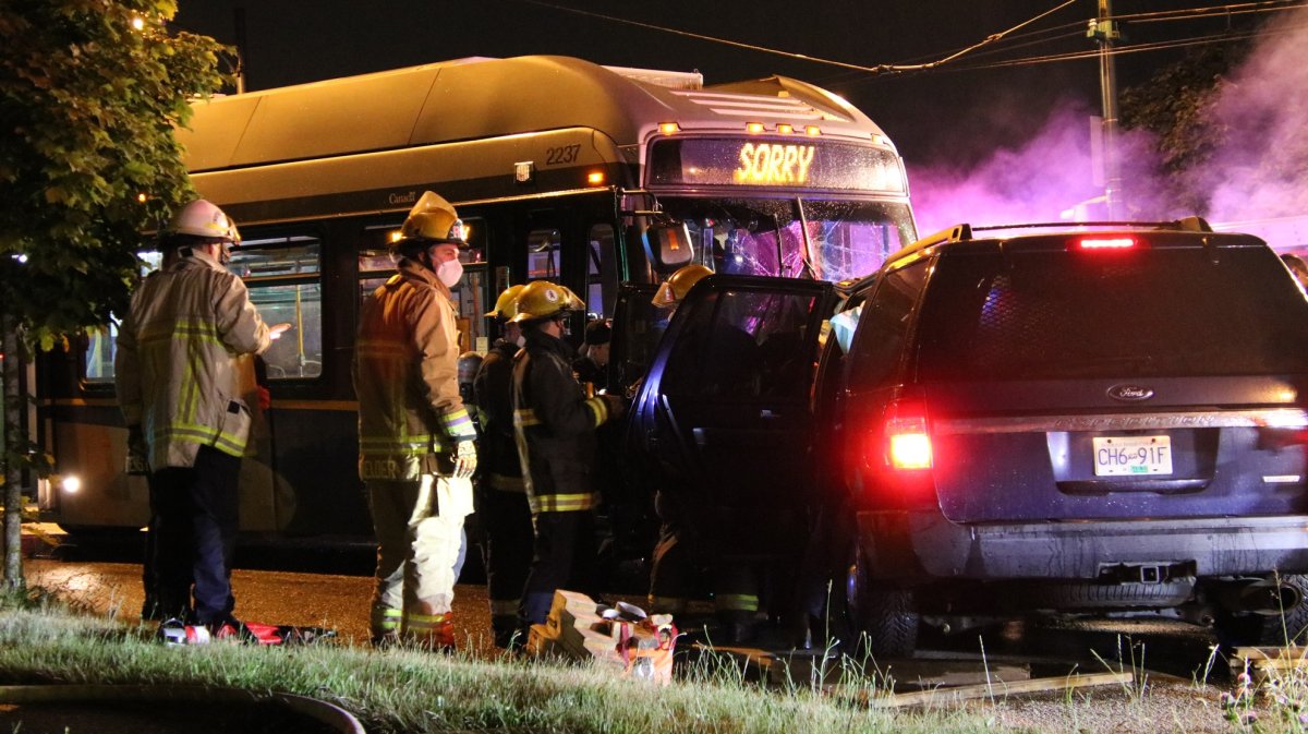 Firefighters respond to a crash between a police vehicle and a transit bus in Vancouver Friday night. 