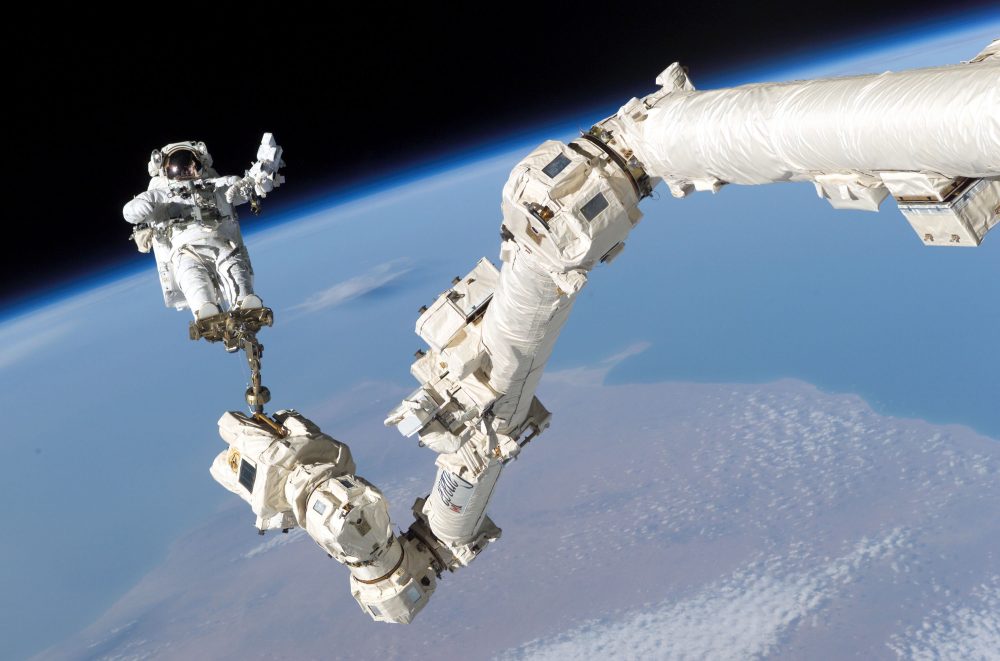 This Aug. 3, 2005 file photo shows an astronaut anchored to the Canadarm2 robotic arm on the International Space Station.