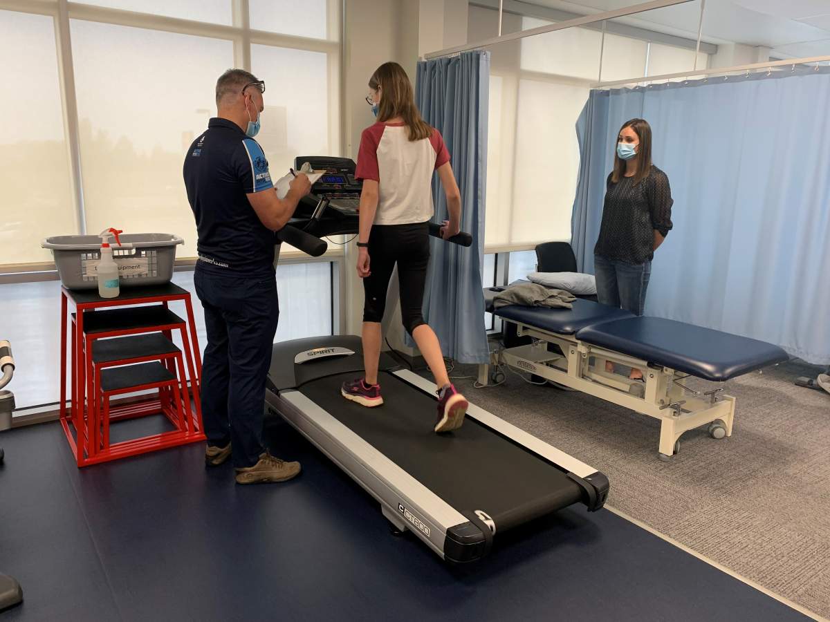 Kinsley Esch, works with physical therapist, James Dean, to build up cardiovascular strength after COVID-19 illness.