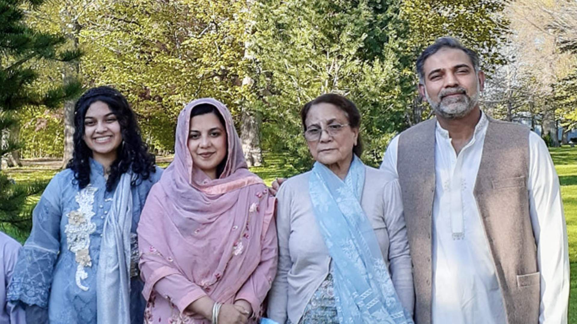 A photo of a family standing outside.