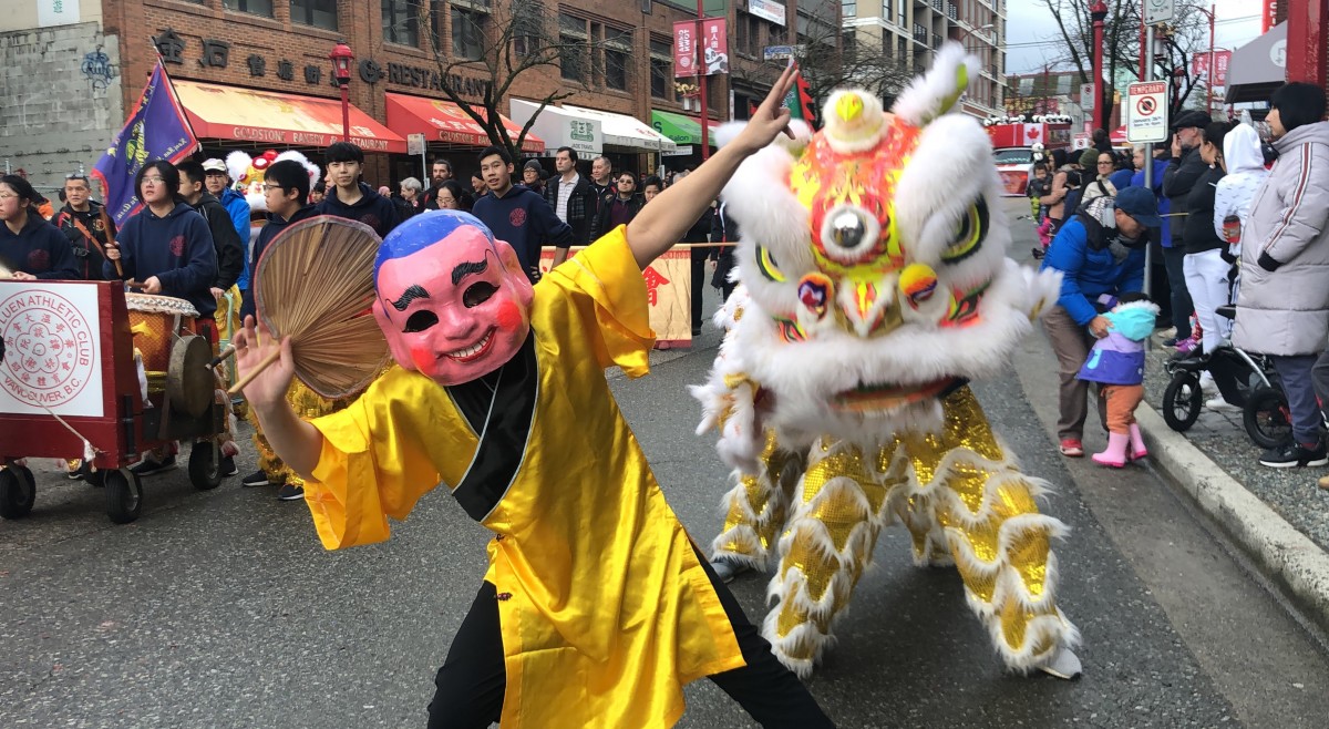 Michael Tan, who has performed in more than 20 Chinese New Year parades, leads the lion dance in a Buddha costume at the 2020 event in Chinatown.