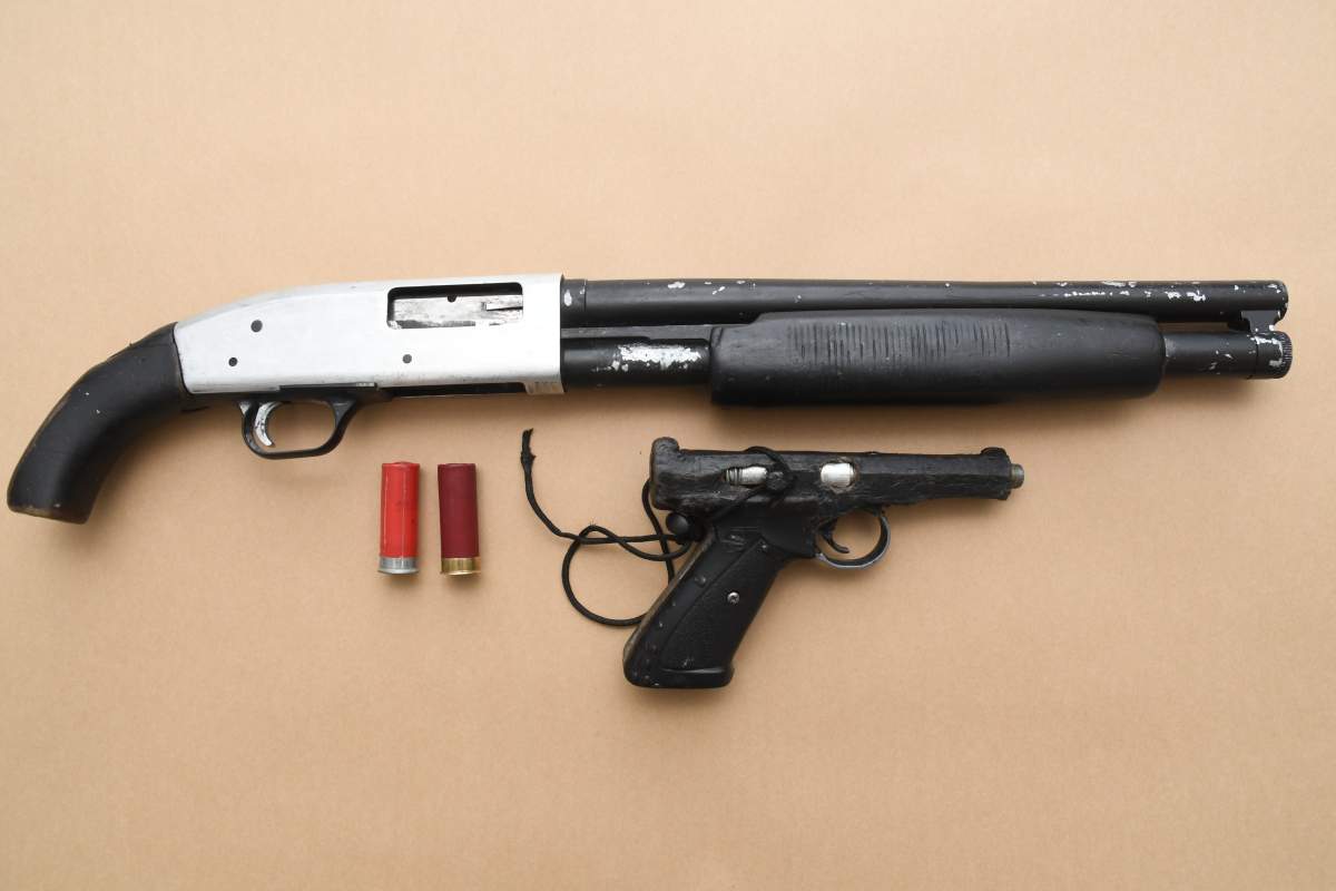 a loaded Mossberg 12 Gauge shotgun and a loaded improvised firing device