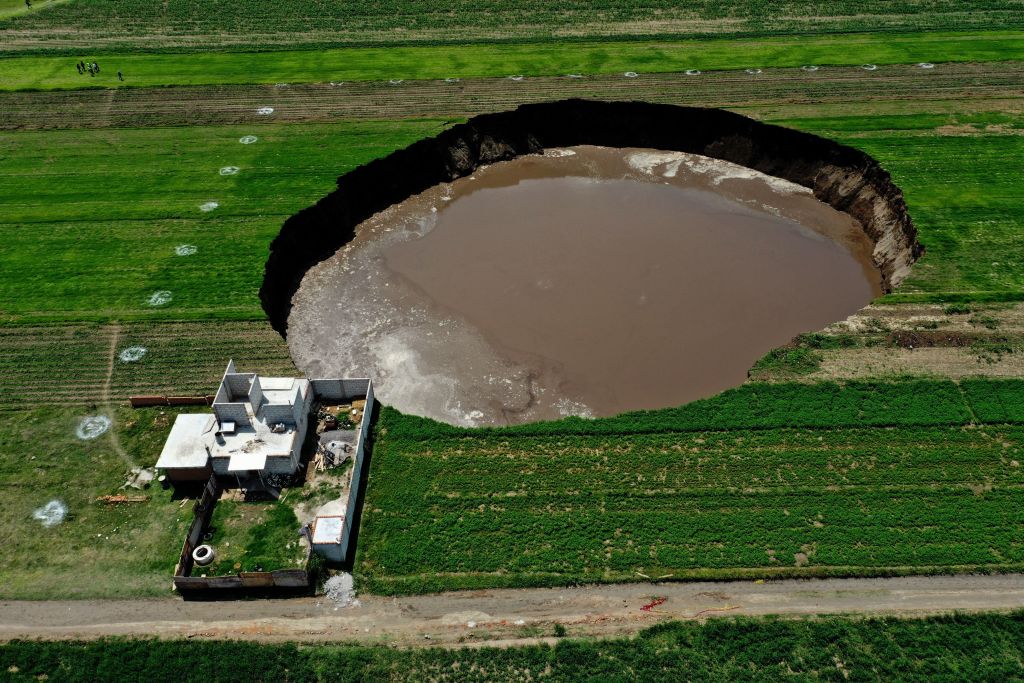 Aerial view of a sinkhole that was found by farmers in a field of crops in Santa Maria Zacatepec, state of Puebla, Mexico on June 01, 2021.