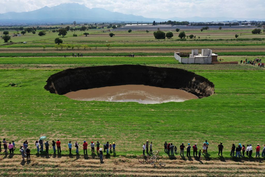 Aerial view of a sinkhole that was found by farmers in a field of crops in Santa Maria Zacatepec, state of Puebla, Mexico on May 30, 2021.