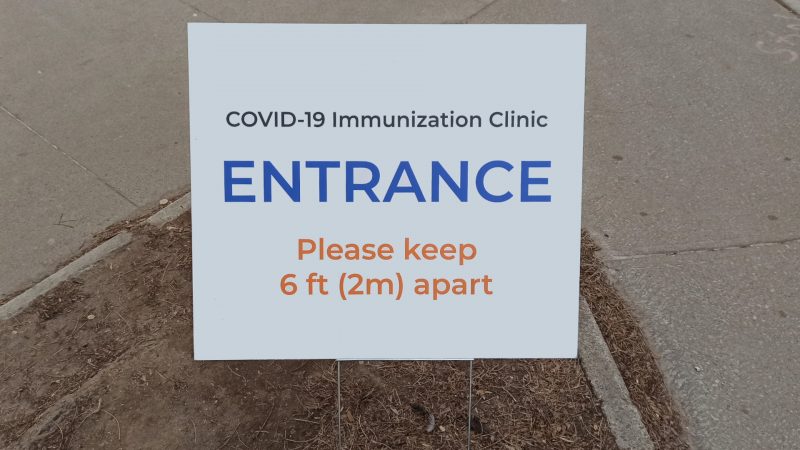 FILE: a COVID-19 vaccination clinic sign. 
