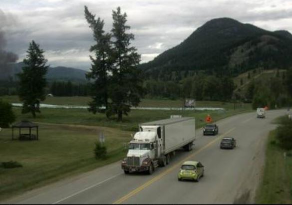 This Drive BC camera is situated at Hwy 5, in Little Fort at Hwy 5/Hwy 24 junction, looking north. It appears black smoke can be seen on the left of the image.


