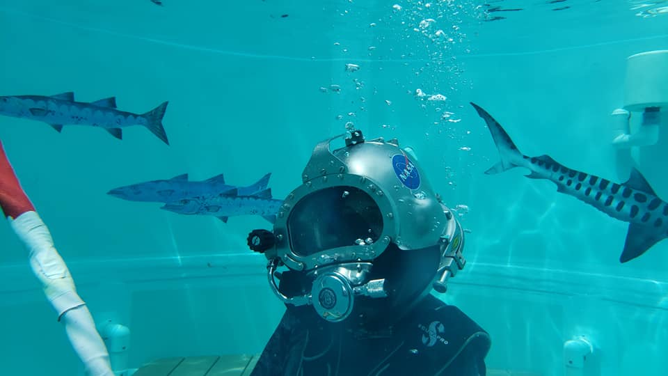 Dr. Shawna Pandya tries on a Kirby-Morgan helmet during her Dive Medical Technician training at the Aquarius Reef Base.