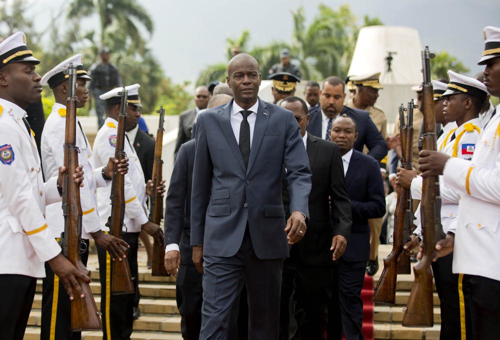 In this April 7, 2018, file photo, Haiti’s President Jovenel Moise, center, leaves the museum during a ceremony marking the 215th anniversary of revolutionary hero Toussaint Louverture’s death, at the National Pantheon museum in Port-au-Prince, Haiti.