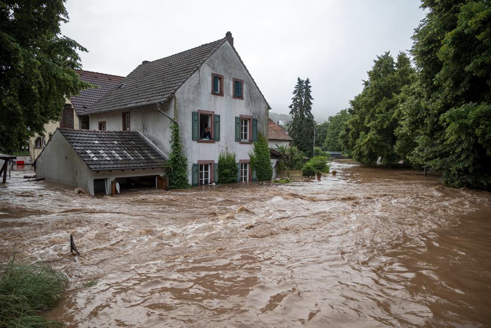 Houses are submerged on the overflowed river banks in Erdorf, Germany, as the village was flooded Thursday, July 15, 2021.