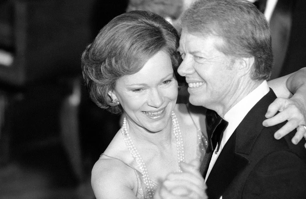 FILE – In this Dec. 13, 1978 file photo, President Jimmy Carter and his wife Rosalynn lead their guests in dancing at the annual Congressional Christmas Ball at the White House in Washington. (AP Photo/Ira Schwarz, File)