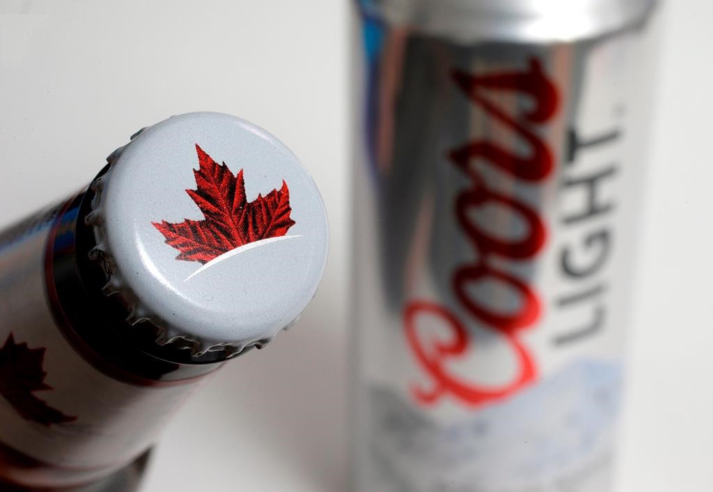 Molson Canadian, left, and Coors Light beer products are displayed together in Walpole, Mass., on Nov. 28, 2017. 