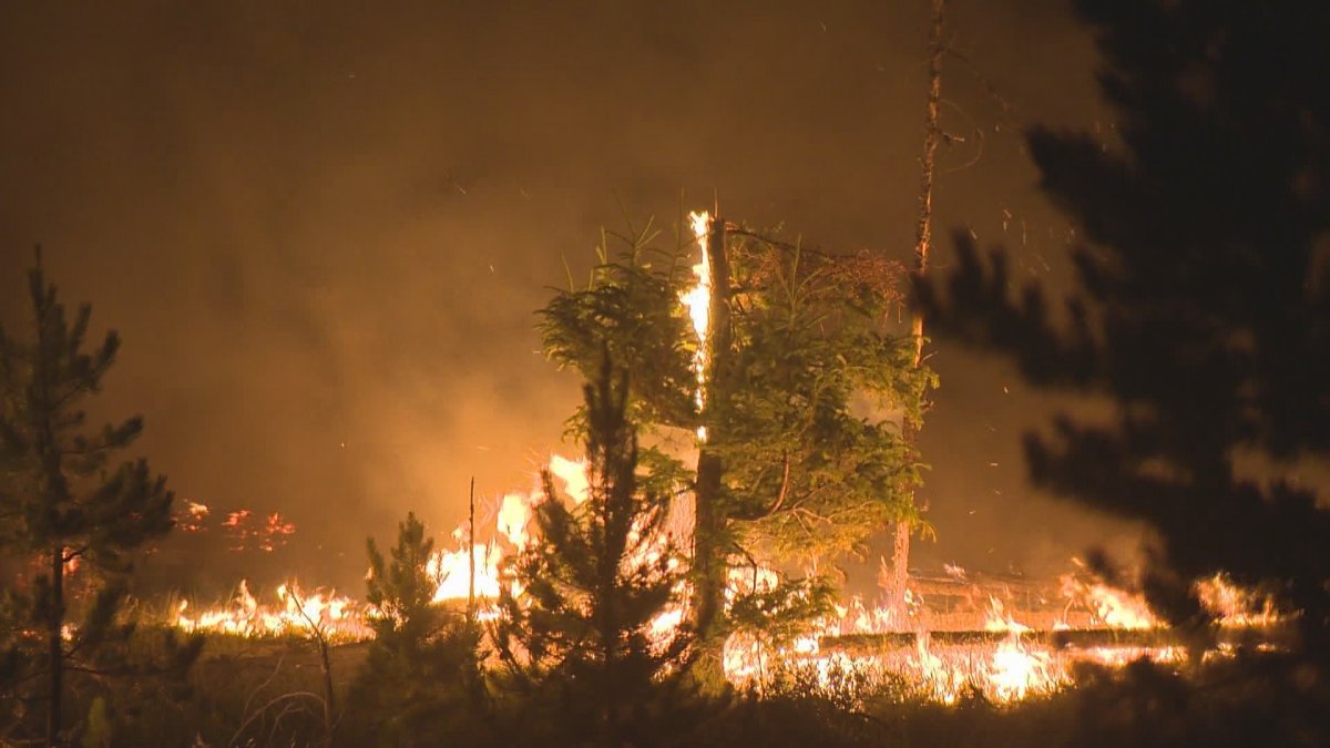 The Flat Lake fire burning near ranchers' lands near 100 Mile.