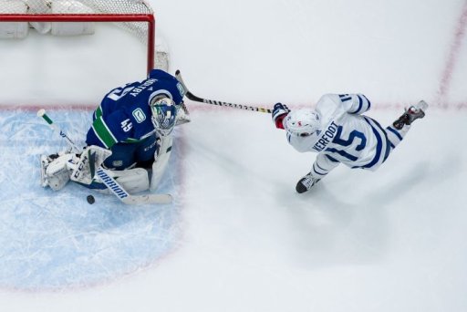 Vancouver Canucks goalie Braden Holtby, left, stops Toronto Maple Leafs’ Alexander Kerfoot during the first period of an NHL hockey game in Vancouver, on Tuesday, April 20, 2021.