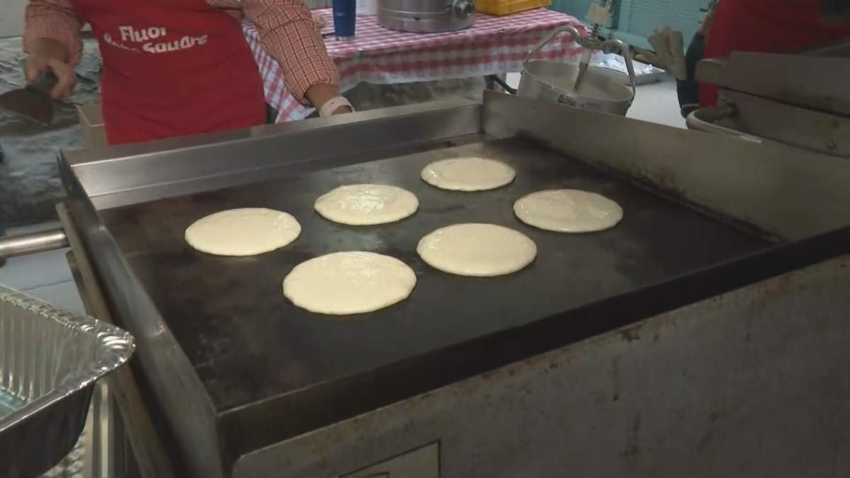 Volunteers served up sausages and pancakes at the premier’s pancake breakfast on Monday, July 12.